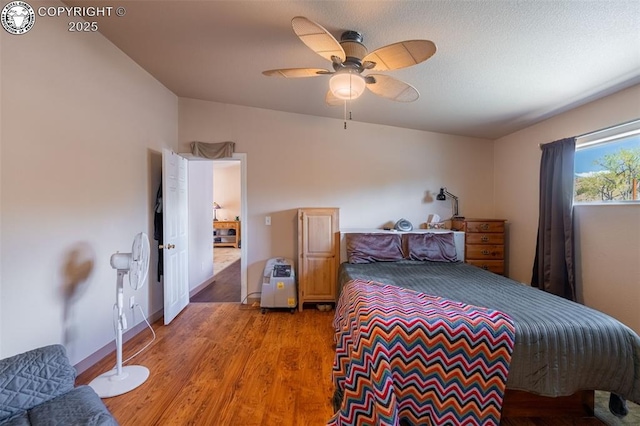 bedroom featuring light wood-type flooring and a ceiling fan