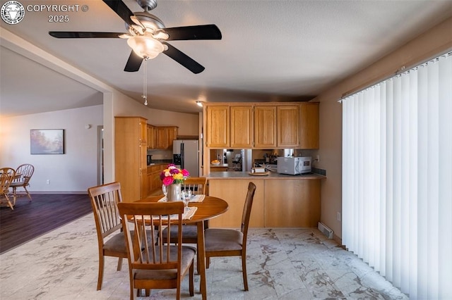 dining area featuring baseboards, a ceiling fan, and visible vents