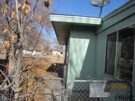 rear view of house with central AC unit