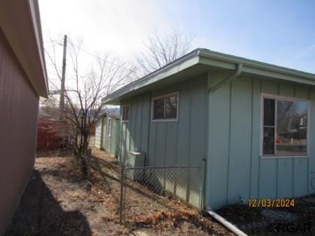 view of home's exterior with fence and board and batten siding