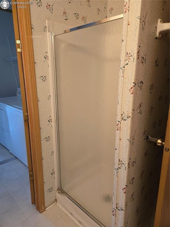 213 Indian Hills Rd, Florence, CO 81226 - bathroom featuring a shower stall, washer / clothes dryer, and tile patterned floors