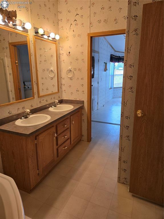213 Indian Hills Rd, Florence, CO 81226 - full bath with wallpapered walls and double vanity