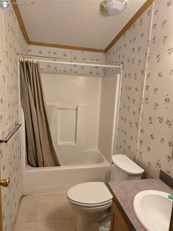 213 Indian Hills Rd, Florence, CO 81226 - full bathroom with wallpapered walls, ornamental molding, lofted ceiling, vanity, and a textured ceiling
