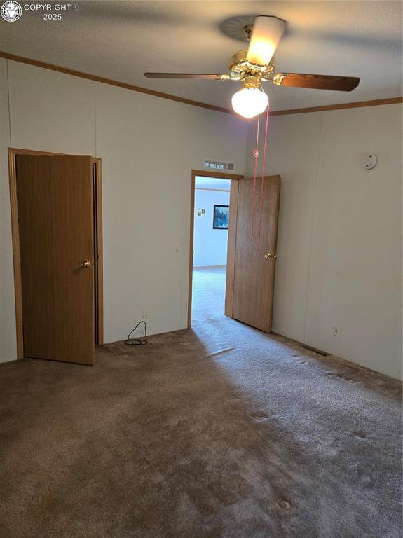 213 Indian Hills Rd, Florence, CO 81226 - carpeted empty room with crown molding and ceiling fan