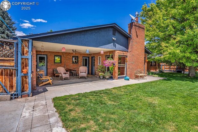 1124 Grand Ave, Canon City, CO 81212 - rear view of house featuring a chimney, a patio, and brick siding