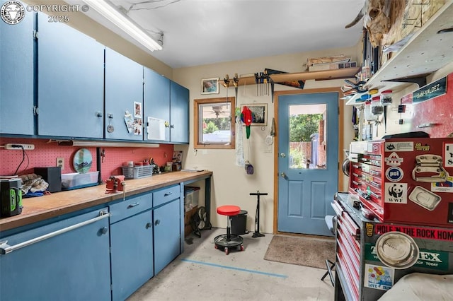1124 Grand Ave, Canon City, CO 81212 - kitchen with blue cabinetry, concrete flooring, and light countertops
