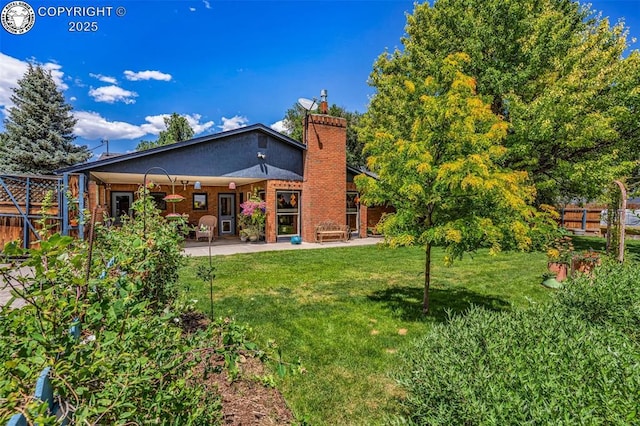 1124 Grand Ave, Canon City, CO 81212 - rear view of property with a patio, a chimney, and brick siding