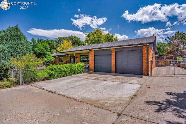 1124 Grand Ave, Canon City, CO 81212 - view of front of house featuring brick siding, concrete driveway, and an attached garage