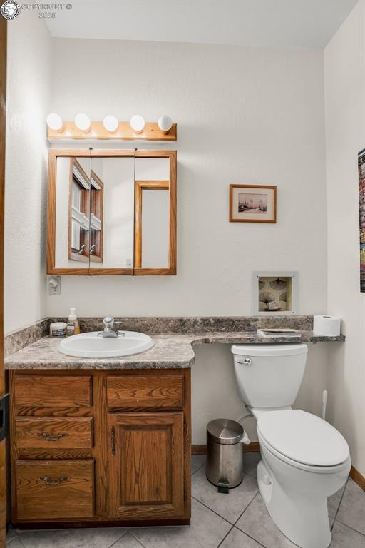 1124 Grand Ave, Canon City, CO 81212 - half bath with vanity and tile patterned floors