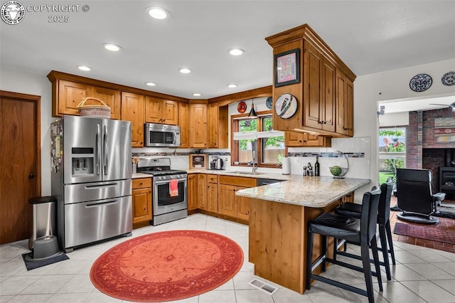 1124 Grand Ave, Canon City, CO 81212 - kitchen with stainless steel appliances, plenty of natural light, a peninsula, light stone countertops, and recessed lighting