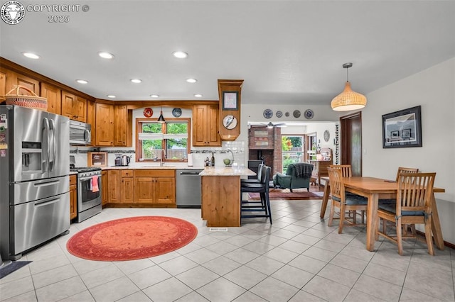 1124 Grand Ave, Canon City, CO 81212 - kitchen featuring appliances with stainless steel finishes, light countertops, backsplash, recessed lighting, and a peninsula