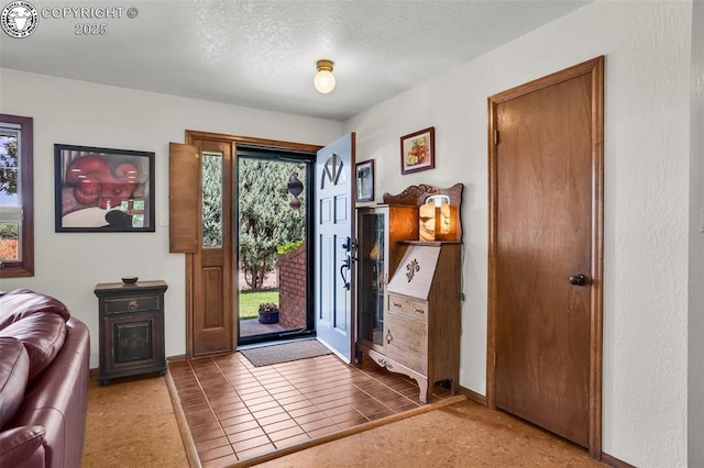 1124 Grand Ave, Canon City, CO 81212 - foyer entrance featuring plenty of natural light, a textured ceiling, and tile patterned flooring