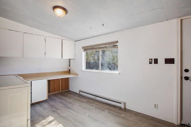 laundry area with a baseboard heating unit, light hardwood / wood-style flooring, and washer / clothes dryer