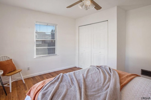 bedroom featuring wood-type flooring, a closet, and ceiling fan