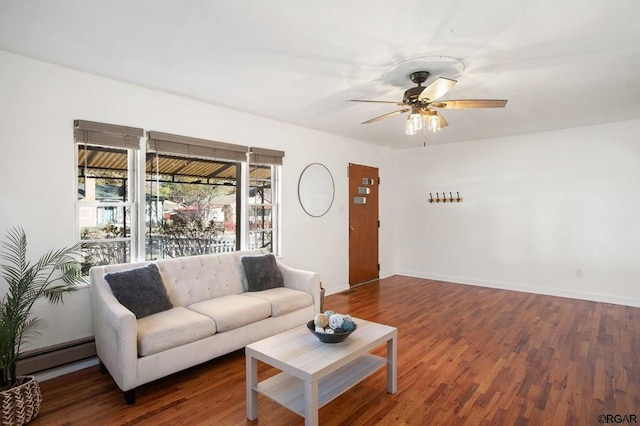 living room with ceiling fan, a baseboard heating unit, and dark hardwood / wood-style flooring