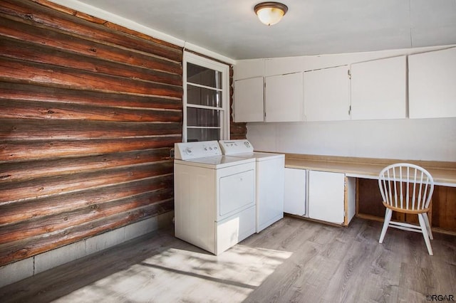 laundry area featuring cabinets, washing machine and dryer, and light wood-type flooring