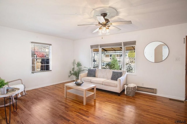 living room with ceiling fan, hardwood / wood-style floors, and a baseboard heating unit