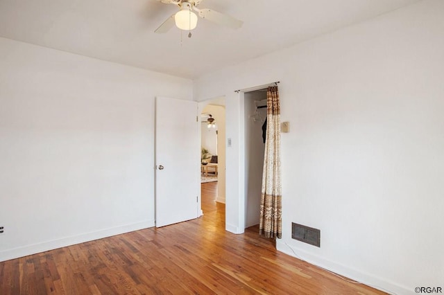 spare room with hardwood / wood-style floors and ceiling fan