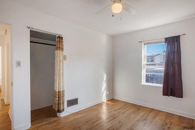 unfurnished bedroom with ceiling fan and light hardwood / wood-style flooring