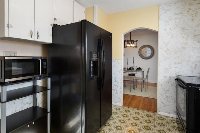 kitchen with black appliances and white cabinets