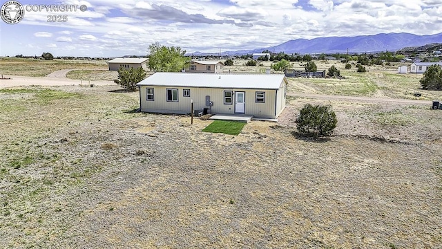 back of house with a mountain view