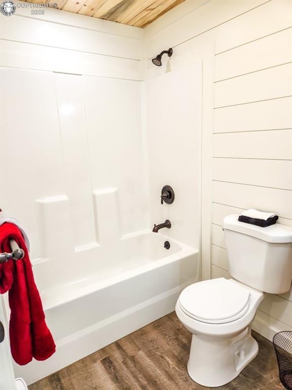 bathroom featuring toilet, tub / shower combination, wood finished floors, and wood ceiling