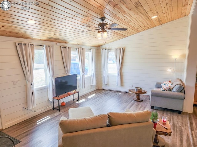 living area featuring a wealth of natural light, a ceiling fan, vaulted ceiling, and wooden ceiling