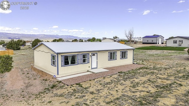view of front of house with a mountain view and metal roof