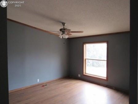 unfurnished room with baseboards, ceiling fan, and wood finished floors