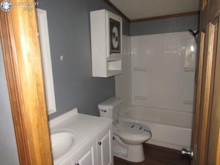 bathroom with vanity, toilet, and shower / tub combination