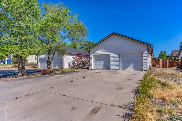 view of side of property with a garage and an outdoor structure