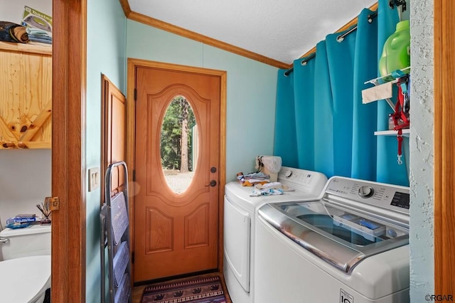 laundry room featuring ornamental molding and separate washer and dryer