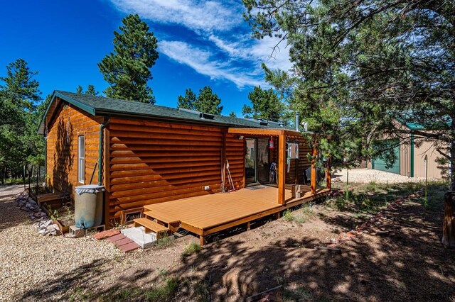 back of house featuring a deck