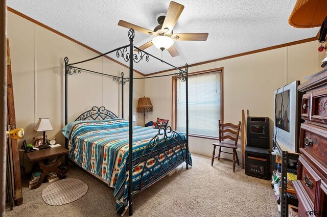 carpeted bedroom with crown molding, a textured ceiling, and ceiling fan