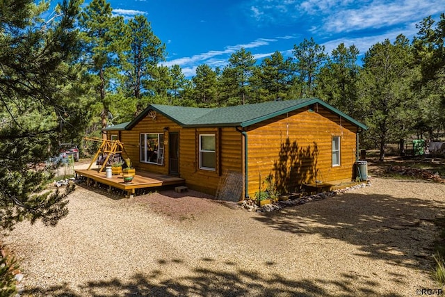 view of side of home with a deck