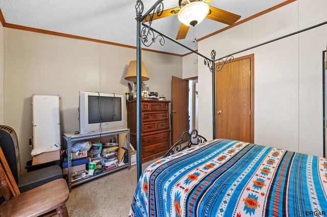 bedroom featuring crown molding, carpet floors, a textured ceiling, and ceiling fan