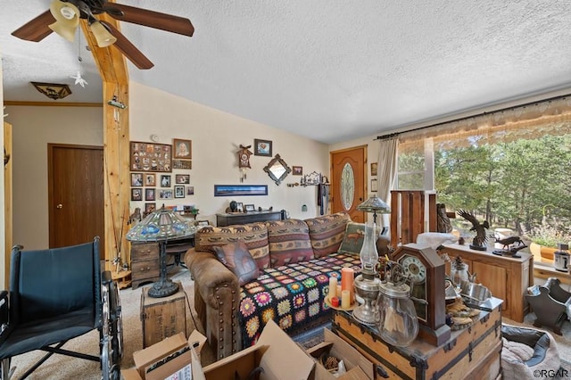 living room featuring ceiling fan, carpet floors, and a textured ceiling