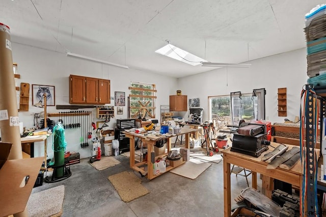 misc room with concrete flooring and a workshop area