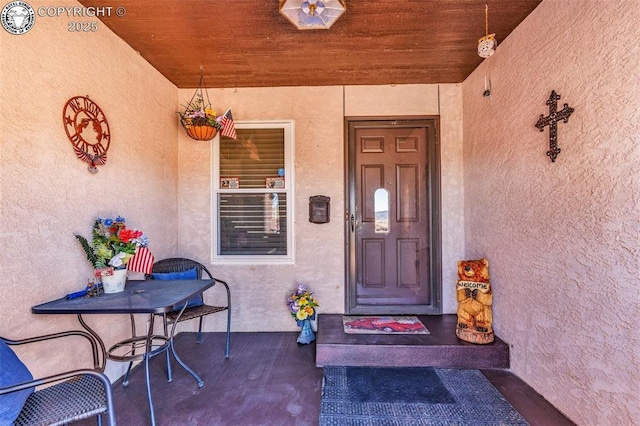 view of exterior entry featuring stucco siding