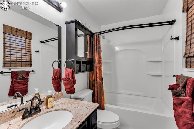 bathroom featuring shower / bath combo with shower curtain, toilet, and vanity