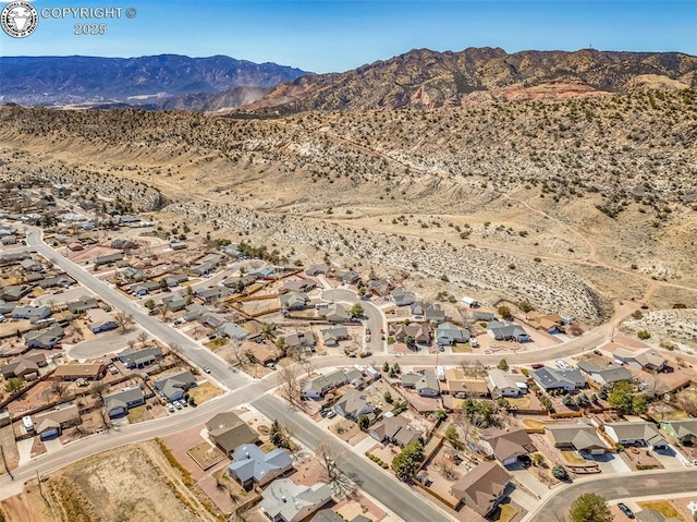 aerial view with a residential view, a mountain view, and a desert view