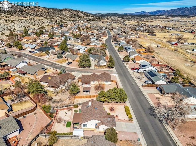 birds eye view of property with a mountain view and a residential view