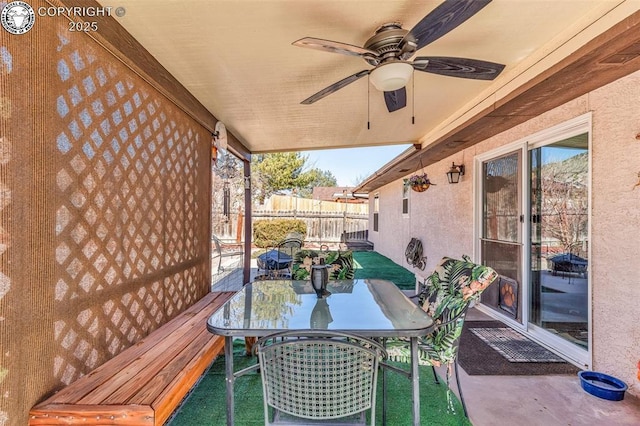 view of patio / terrace with outdoor dining area, a ceiling fan, and fence