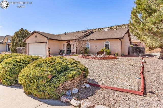 ranch-style home featuring fence, a garage, and stucco siding