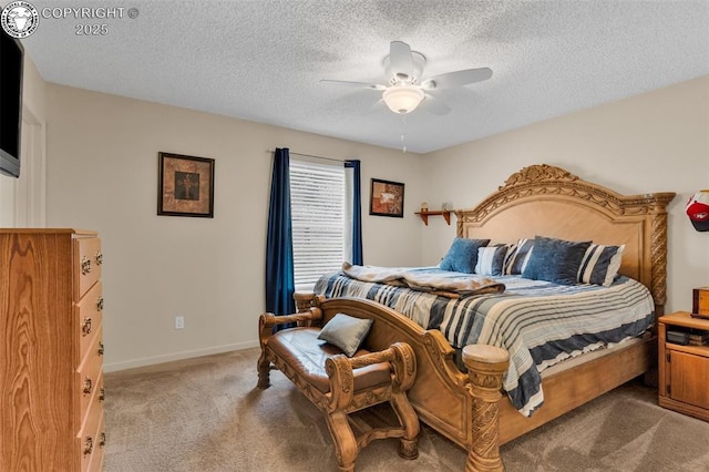 bedroom featuring ceiling fan, light colored carpet, baseboards, and a textured ceiling