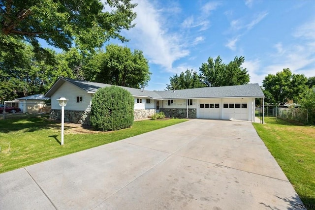 single story home featuring a garage and a front lawn