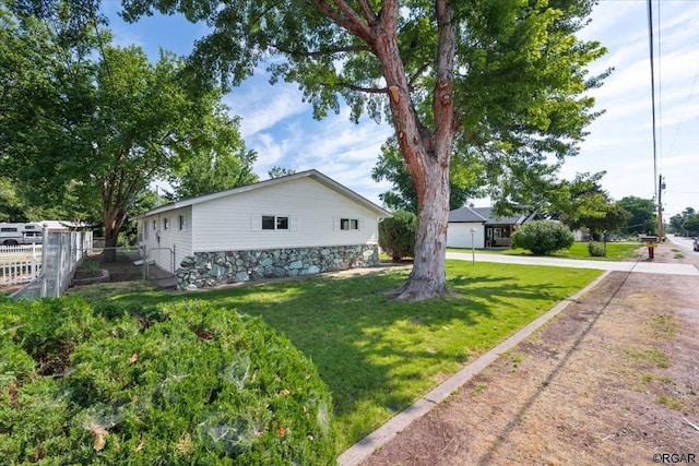 view of side of property with a yard