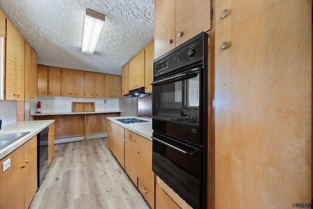 kitchen with black appliances, a textured ceiling, a baseboard radiator, light hardwood / wood-style floors, and backsplash