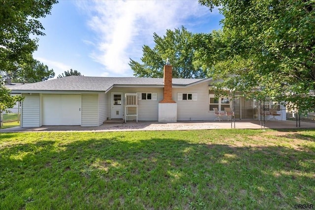 rear view of house with a lawn and a patio