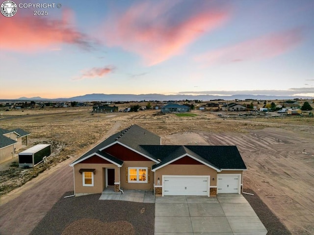 view of front of house featuring a garage and a mountain view